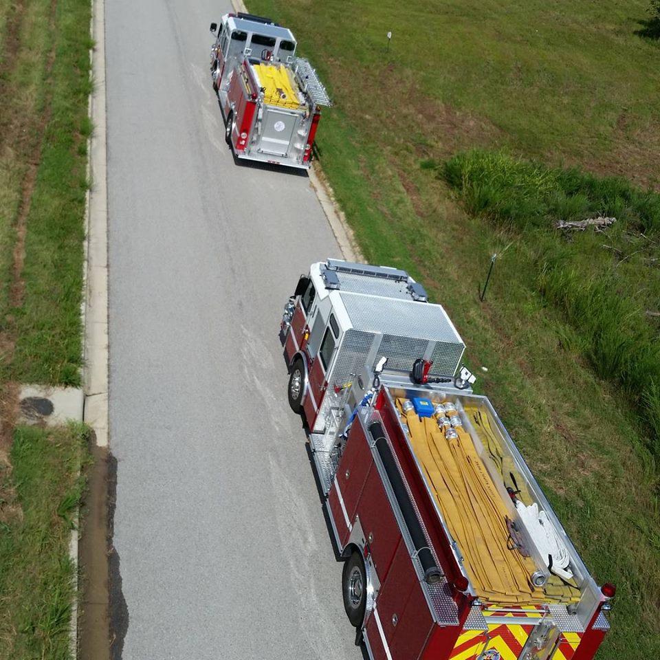aerial view of two fire engines parked on the street